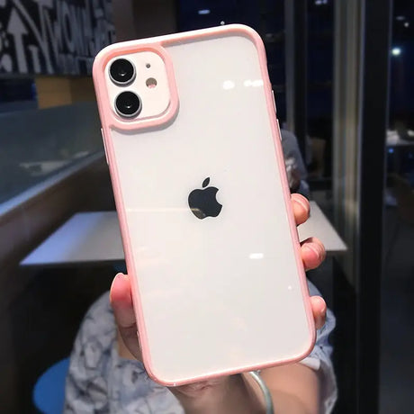 a woman holding up a pink iphone case