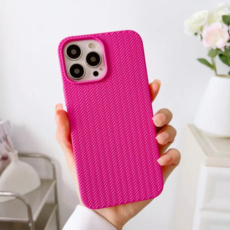 a woman holding a pink iphone case