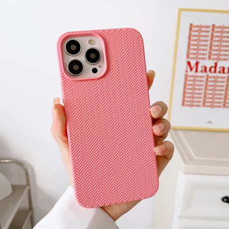 a woman holding a pink iphone case