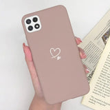 a woman holding a pink phone case with a heart on it