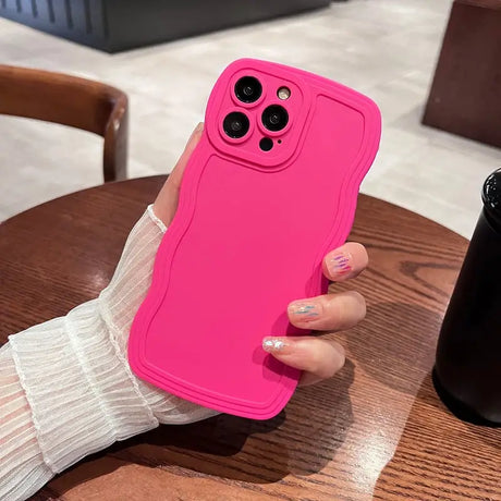 a woman holding a pink iphone case