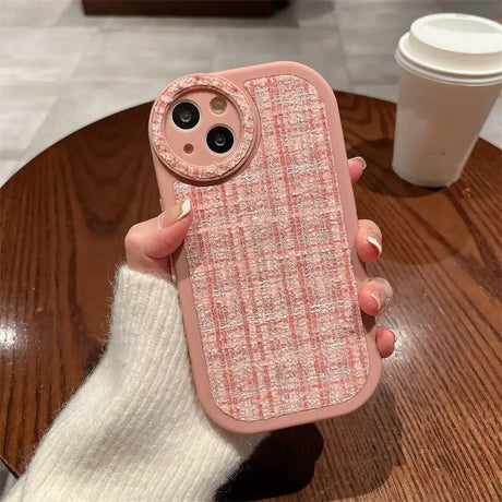 a woman holding a pink iphone case