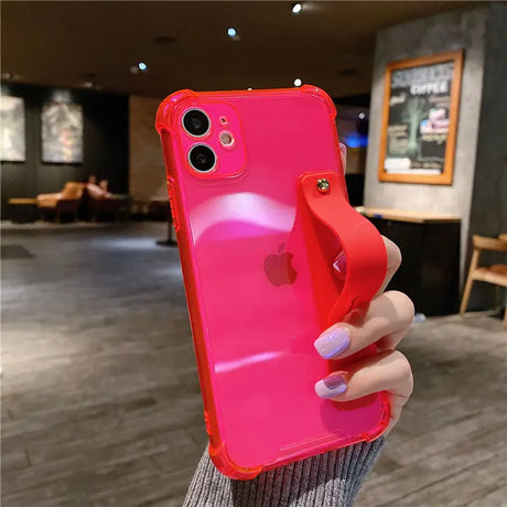 a woman holding a pink iphone case