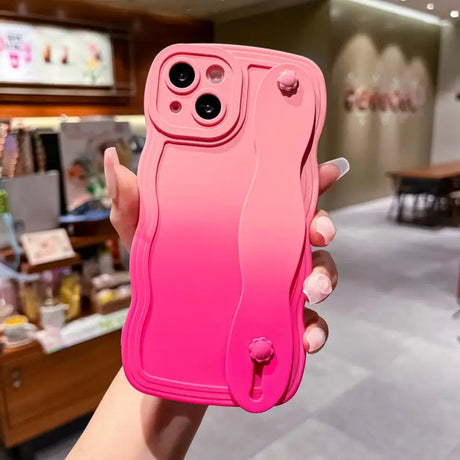 a woman holding up a pink iphone case