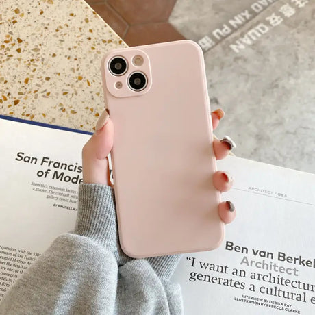 a woman holding a pink iphone case