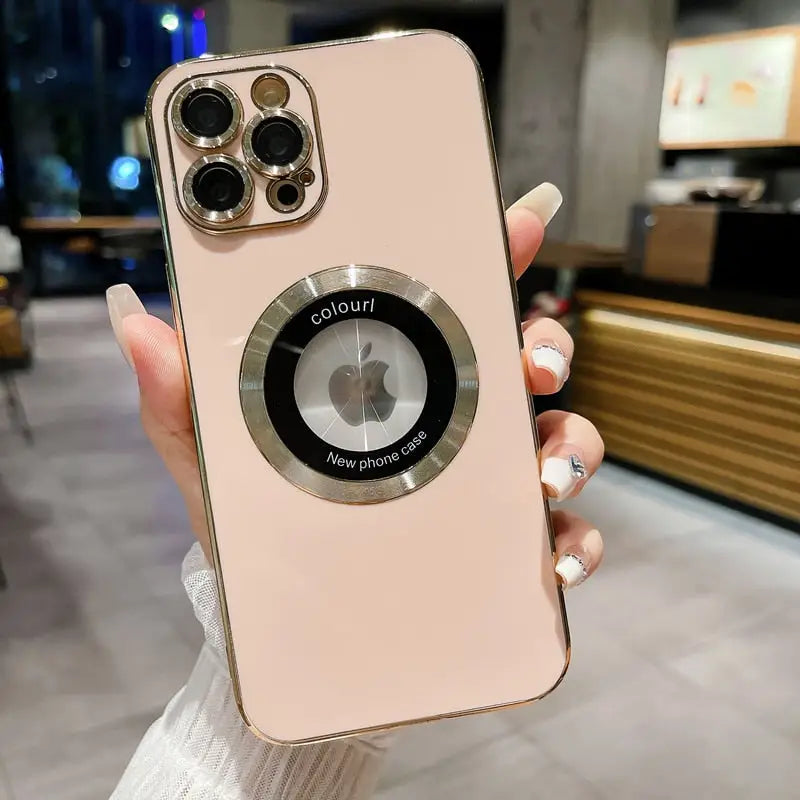 a woman holding a pink iphone case with a camera lens