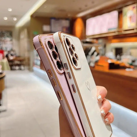 a woman holding up a pink iphone