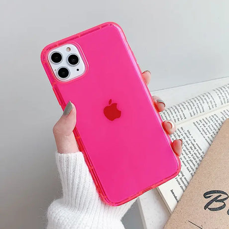 a woman holding a pink iphone case