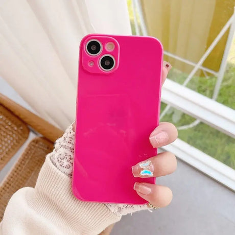 a woman holding a pink phone case