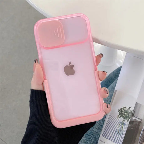 a woman holding a pink iphone case