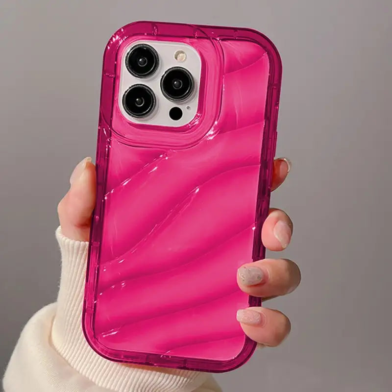 a woman holding a pink iphone case