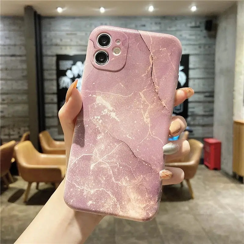 a pink marble phone case with a hole in the middle