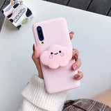 a woman holding a pink phone case with a pig face