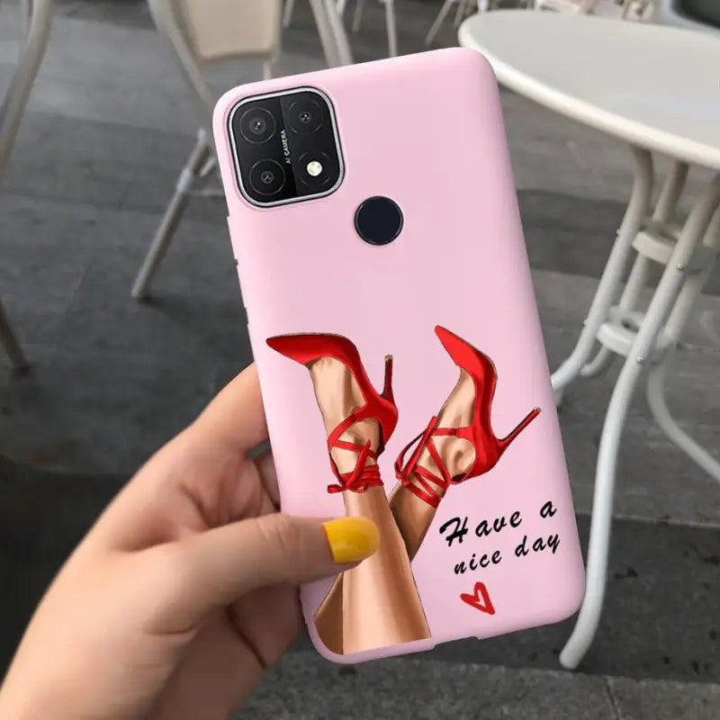 a woman holding a pink phone case with red heels on it