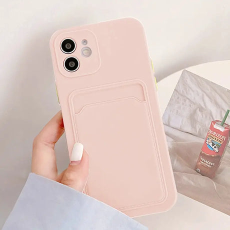 a person holding a pink phone case