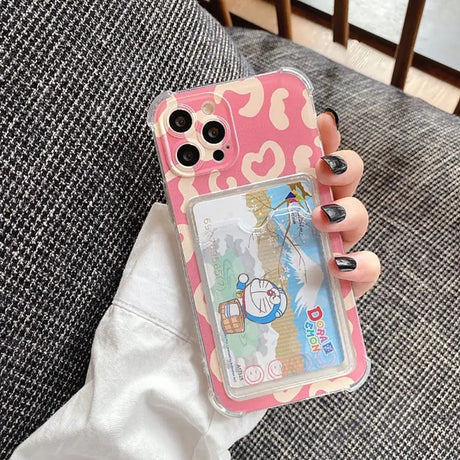 a woman holding a pink phone case with a cartoon character on it