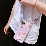 a girl holding a pink phone case with a unicorn on it