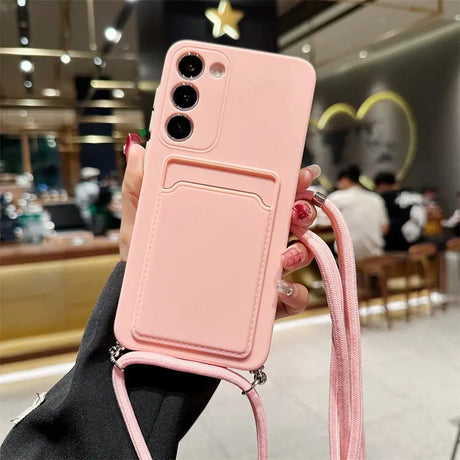 a woman holding a pink phone case