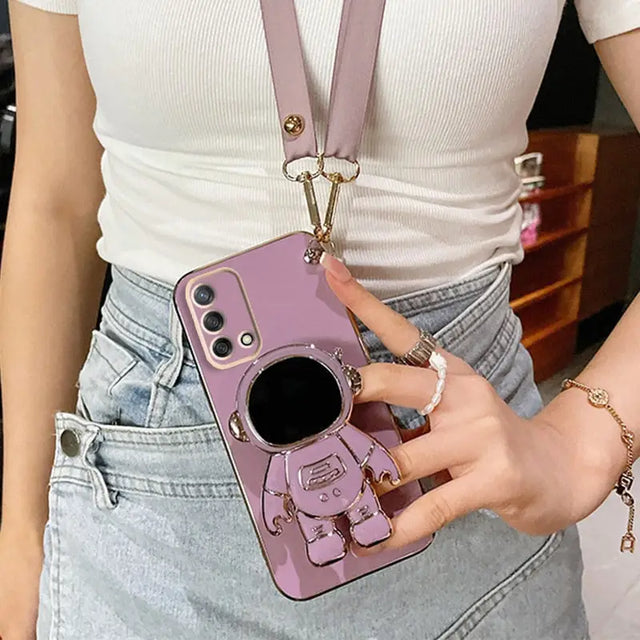 a woman holding a pink phone case with a camera attached to it