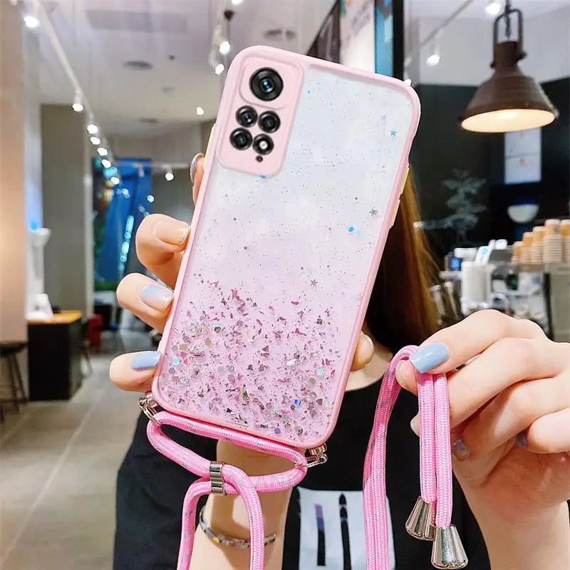 someone holding a pink phone case with a pink strap