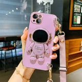 a woman holding a pink phone case with a camera attached to it
