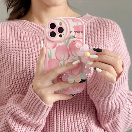 a woman holding a pink phone case