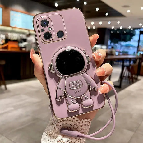 a woman holding a pink phone case with a camera attached to it