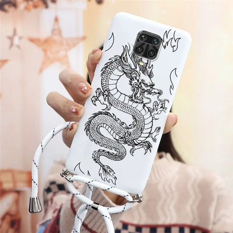 a woman holding a phone case with a dragon on it