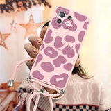 a woman holding a pink phone case with a pink cam pattern
