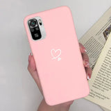 a woman holding a pink phone case with a heart on it