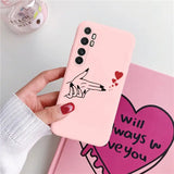a woman holding a pink phone case with a heart drawn on it