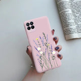 a woman holding a pink phone case with flowers on it