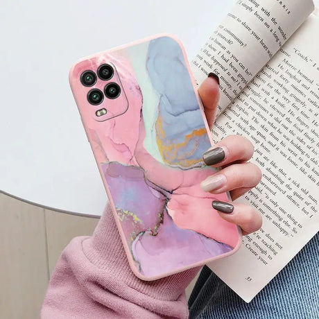 a woman holding a book and holding a phone case