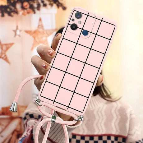 a woman holding a pink phone case with a grid pattern