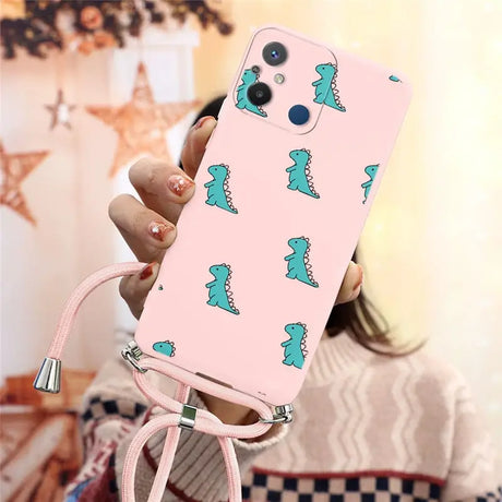 a woman holding a pink phone case with a green dinosaur print