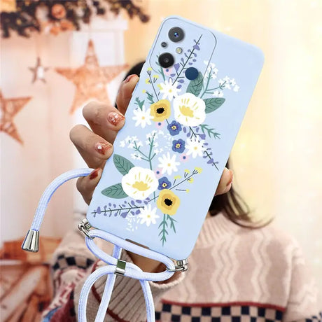 a woman holding a phone case with flowers on it