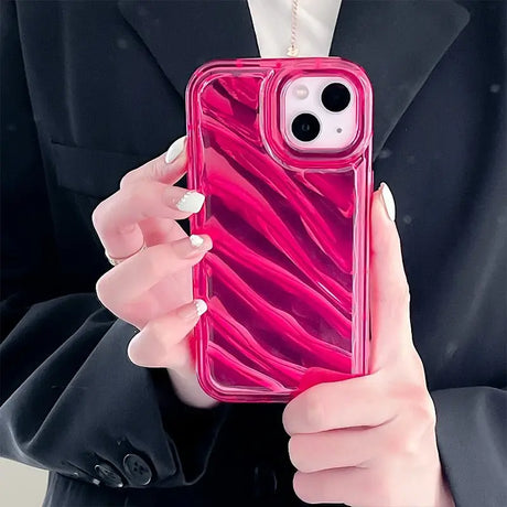 a woman holding a pink phone case