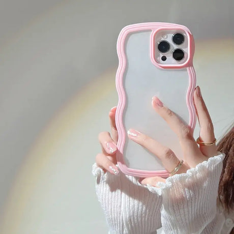 a woman holding a pink phone case