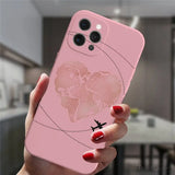 a woman holding a pink phone case with a world map on it