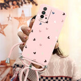 a girl holding a pink phone case with hearts on it