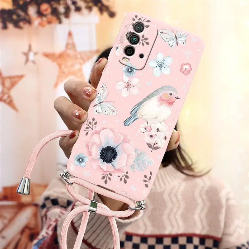 a girl holding a pink phone case with flowers and birds