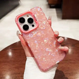 a person holding a pink phone case