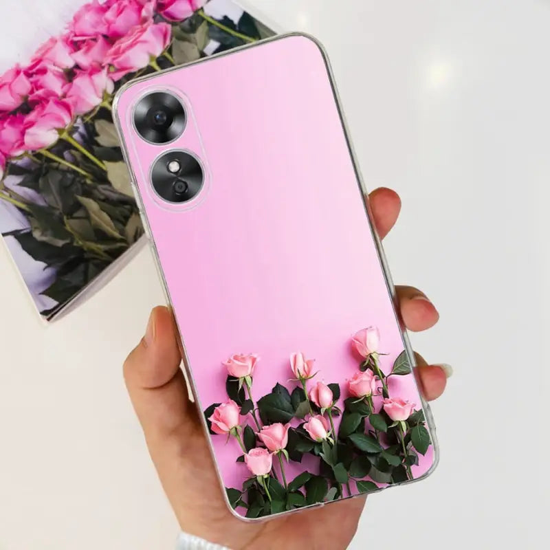 a person holding a pink phone case with flowers