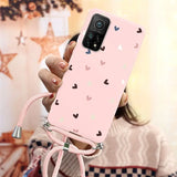 a girl holding a pink phone case with hearts on it