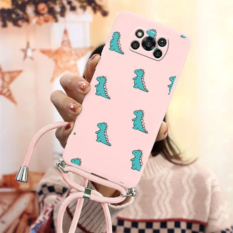 a woman holding a pink phone case with a green dinosaur print