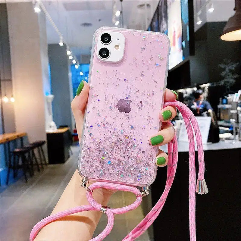 a woman holding a pink phone case with glitter and a pink strap