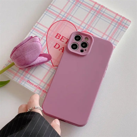 a person holding a pink phone case