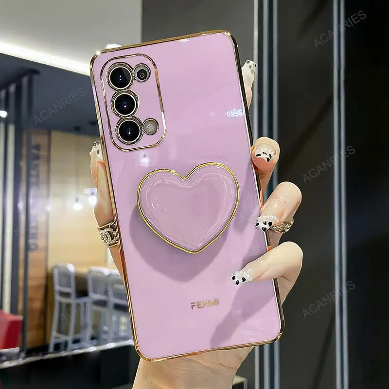 a woman holding a pink phone case with a heart