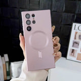 a woman holding up a pink phone case