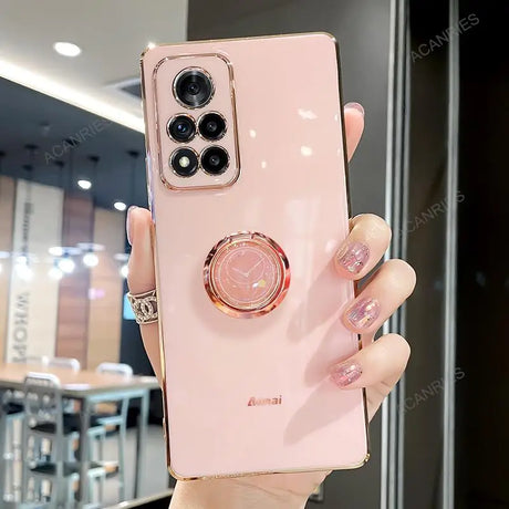 a woman holding a pink phone case with a ring on it